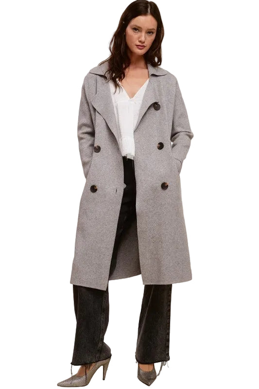 Model wearing a Trestles Clothing Company Beckham Coat in grey cashmere blend with a double-breasted midi silhouette